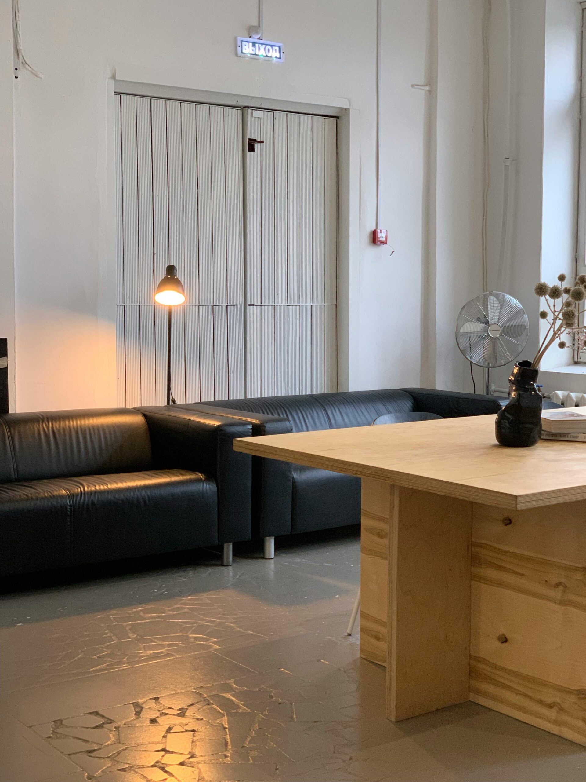 Cozy industrial office space featuring leather sofas and wooden furnishings.