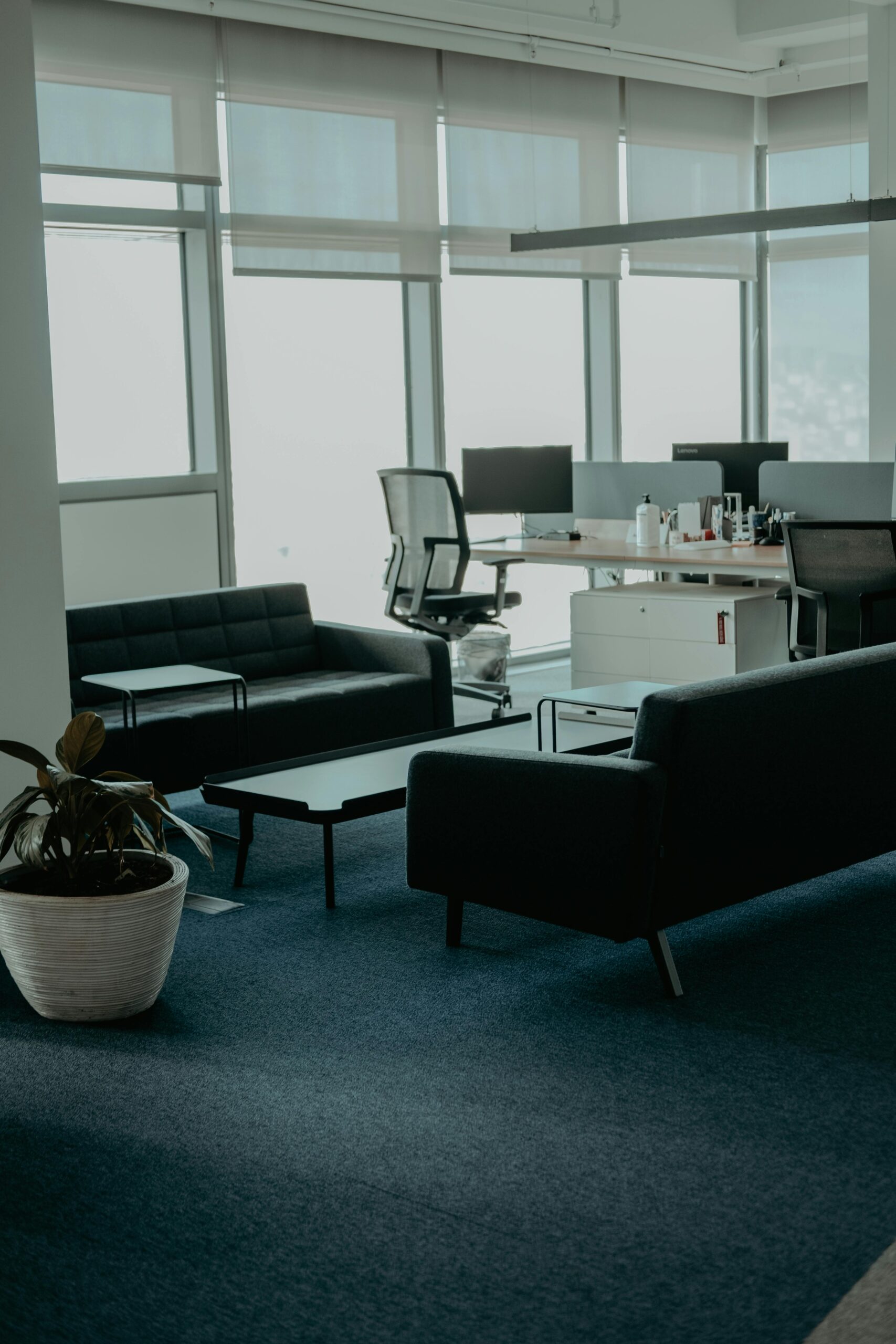A stylish office space with leather sofas and large windows. Perfect for business settings.